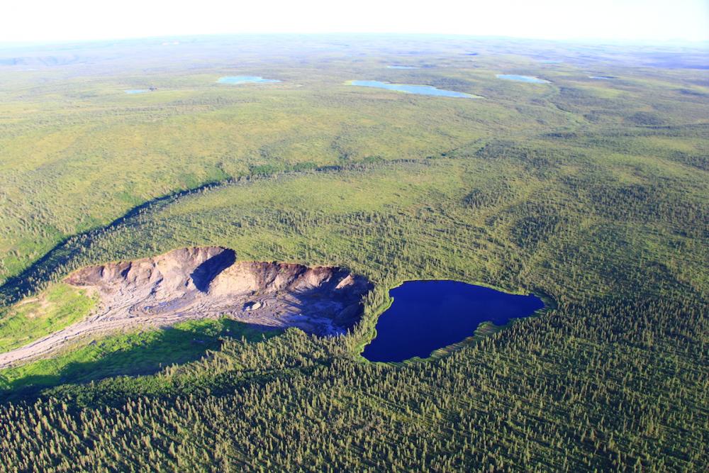 Looking south at a permafrost thaw slump and small lake that is expected to drain catastrophically causing flash flooding near Husky Lake, Gwich'in Settlement Area. Looking south at a permafrost thaw slump and small lake that is expected to drain catastrophically causing flash flooding near Husky Lake, Gwich'in Settlement Area.