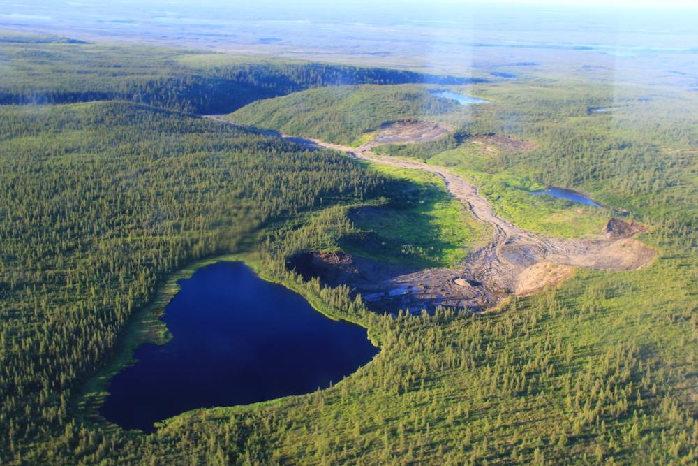 Looking northeast at a permafrost thaw slump and small lake that is expected to drain catastrophically causing flash flooding near Husky Lake, Gwich'in Settlement Area.